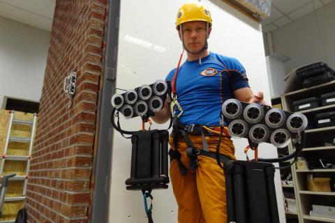 Action adventurer Andy Torbet tries out Draper's Z-Man climbing system before scaling the glass exterior of EF's 10 story building in Cambridge, Massachusetts.