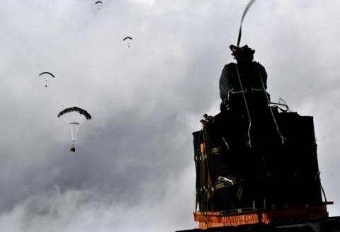 (Army photo) a JPADs pallet lands on target, followed by several others still in the air, during recent testing.